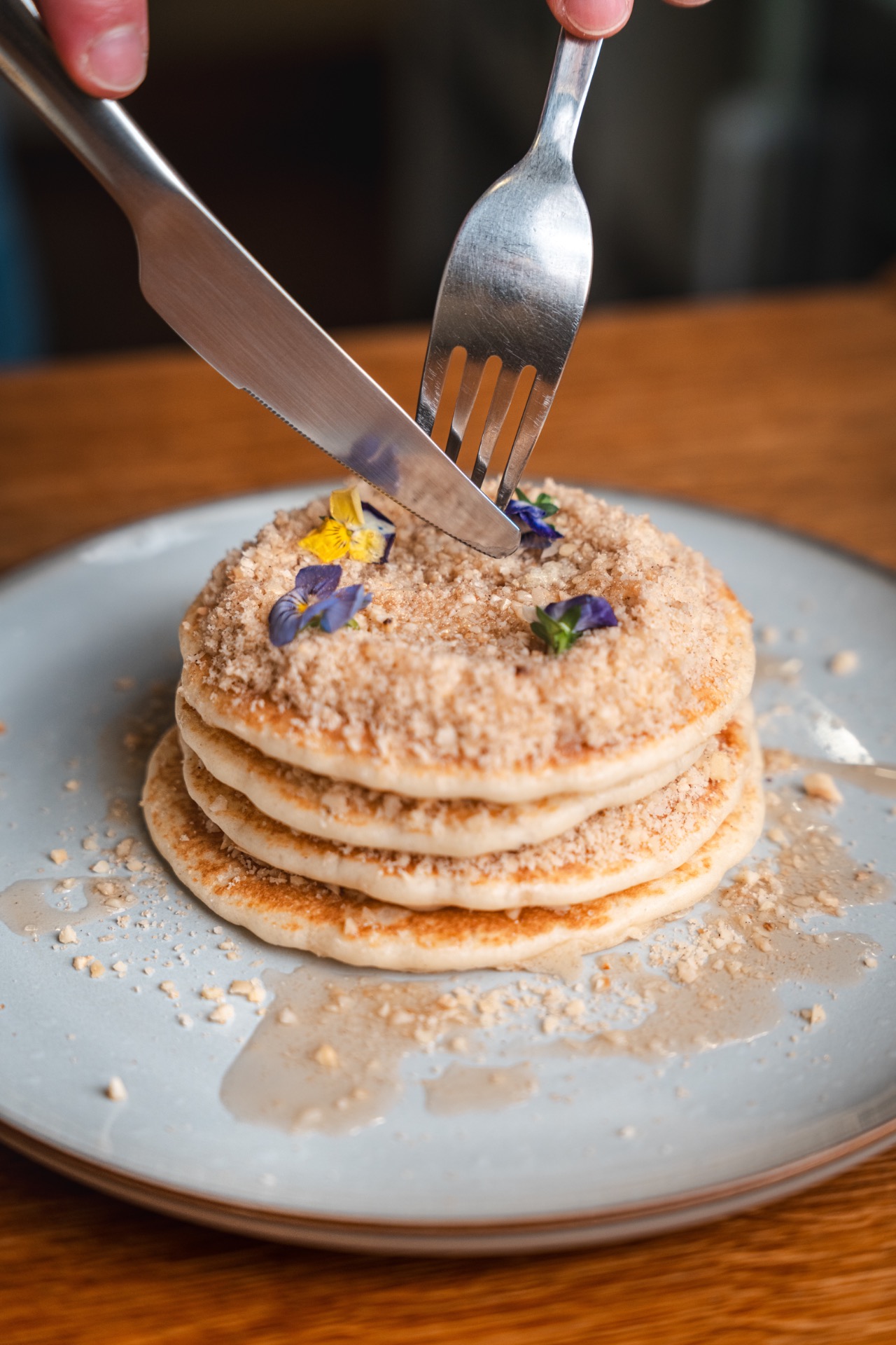Pancakes with hazelnuts, maple syrup, butter in bistro Den Noc